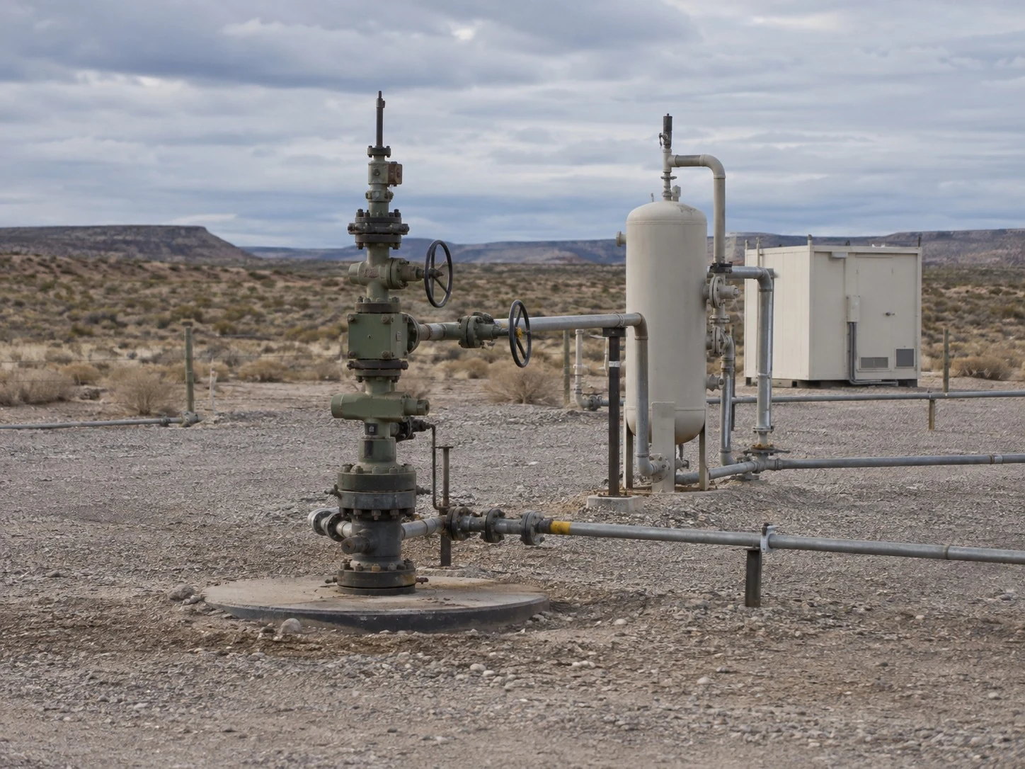 Illustrative wellhead and gas conditioning equipment in a Patagonian landscape